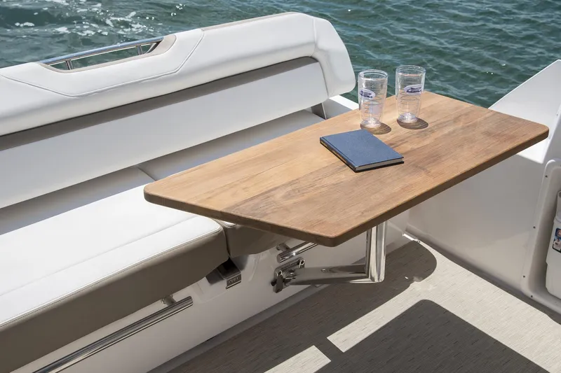 Slide: The Image of Manufacturer Provided Image: 2016 Regal 35 Sport Coupe boat interior with wooden table and seating. - 9