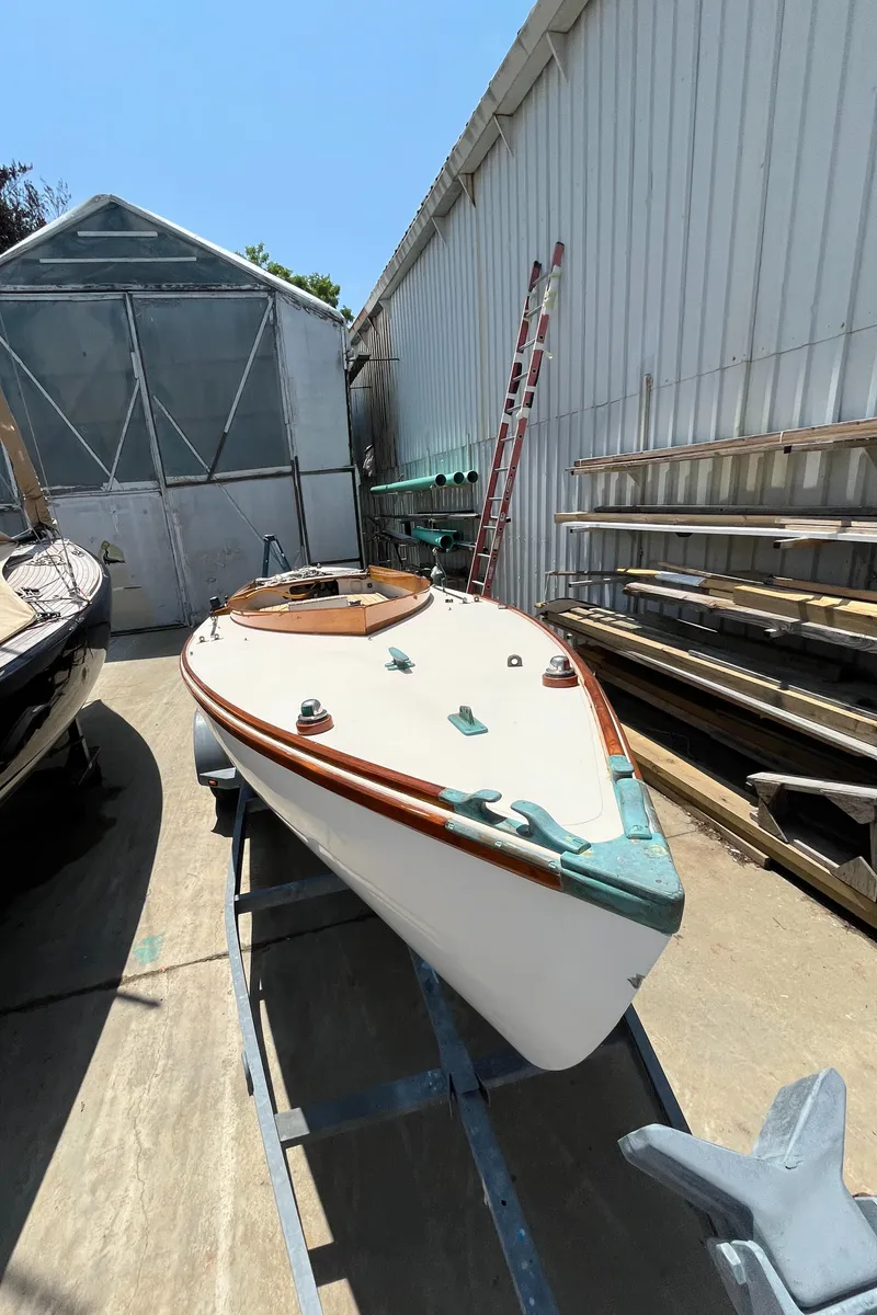 Slide: The Image of Custom Sakonnet 23 sailboat from 2004 on trailer, docked beside a warehouse. - 10
