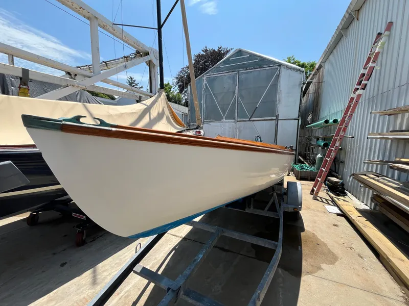 Slide: The Image of Custom Sakonnet 23 sailboat from 2004 on a trailer in a boatyard. - 11
