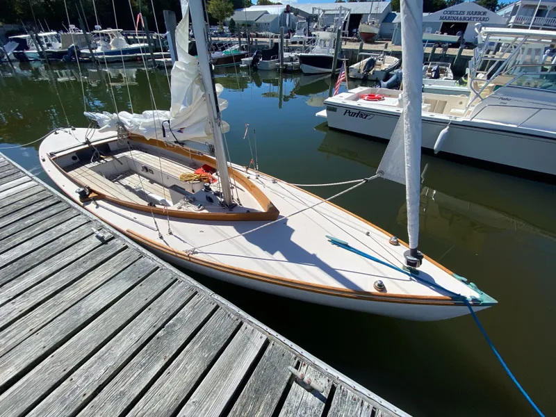 Slide: The Image of Custom Sakonnet 23 sailboat, 2004 model, docked at a marina with other boats. - 2