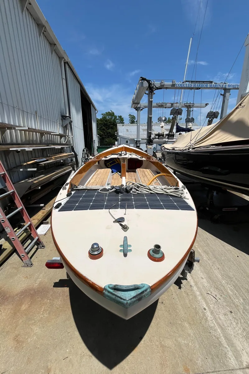 Slide: The Image of Custom Sakonnet 23 boat, 2004 model, docked outdoors under clear blue sky. - 5