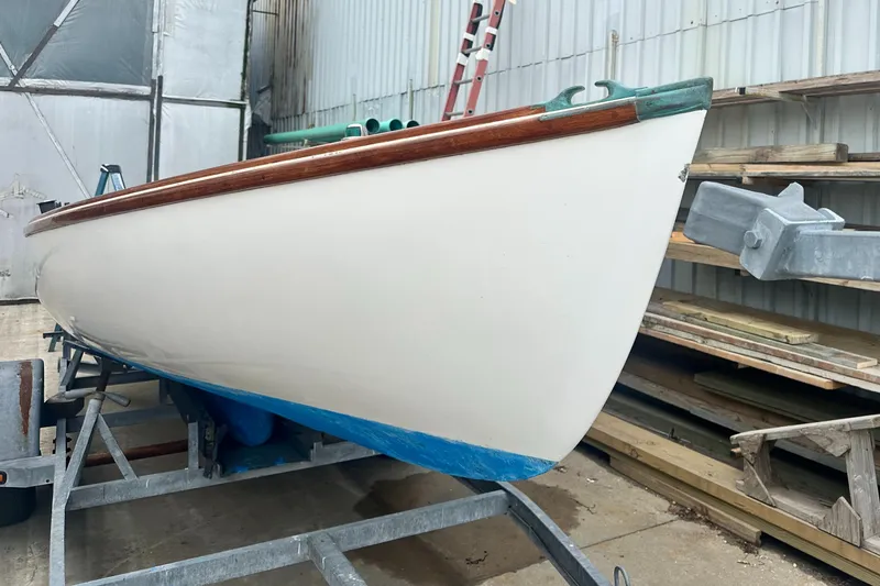 Slide: The Image of Custom Sakonnet 23 sailboat from 2004 on a trailer in a storage area. - 8