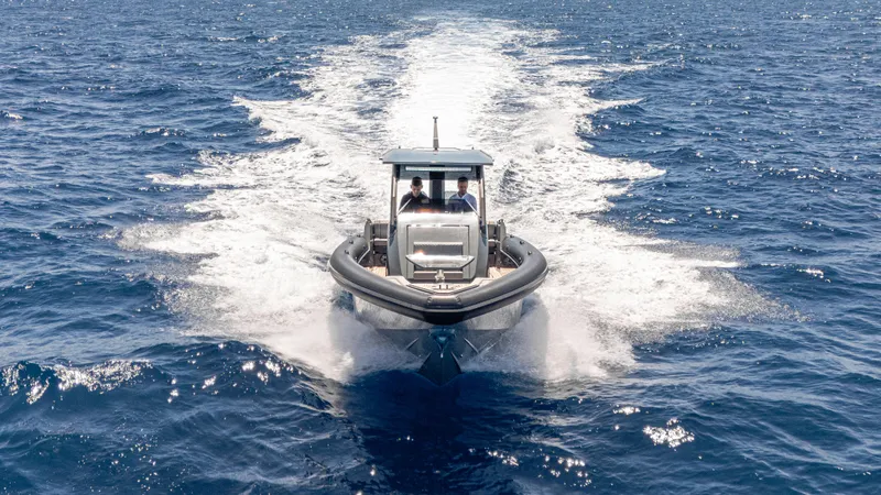Slide: The Image of 2025 Skipper-BSK 38 boat cruising on open sea, leaving a trail of white wake. - 9