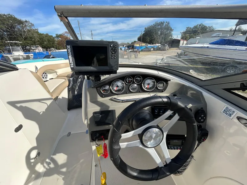 Slide: The Image of 2019 Stingray 240 LR boat dashboard with steering wheel and navigation system. - 19