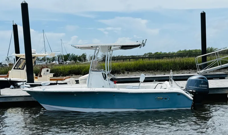 Slide: The Image of 2019 Sea Hunt Ultra 196 boat docked with Yamaha outboard motor. - 2