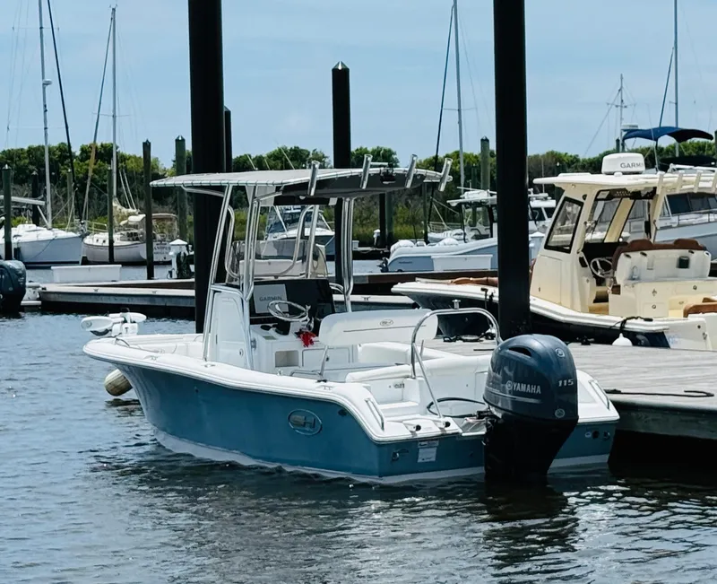 Slide: The Image of 2019 Sea Hunt Ultra 196 boat docked at marina with Yamaha outboard motor. - 3
