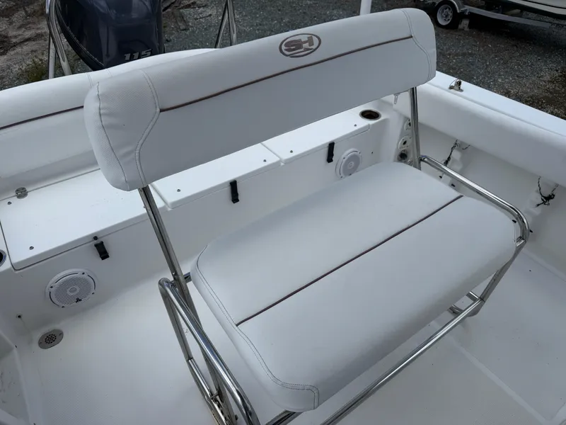 Slide: The Image of 2019 Sea Hunt Ultra 196 boat seating with white upholstery and stainless steel frame. - 6