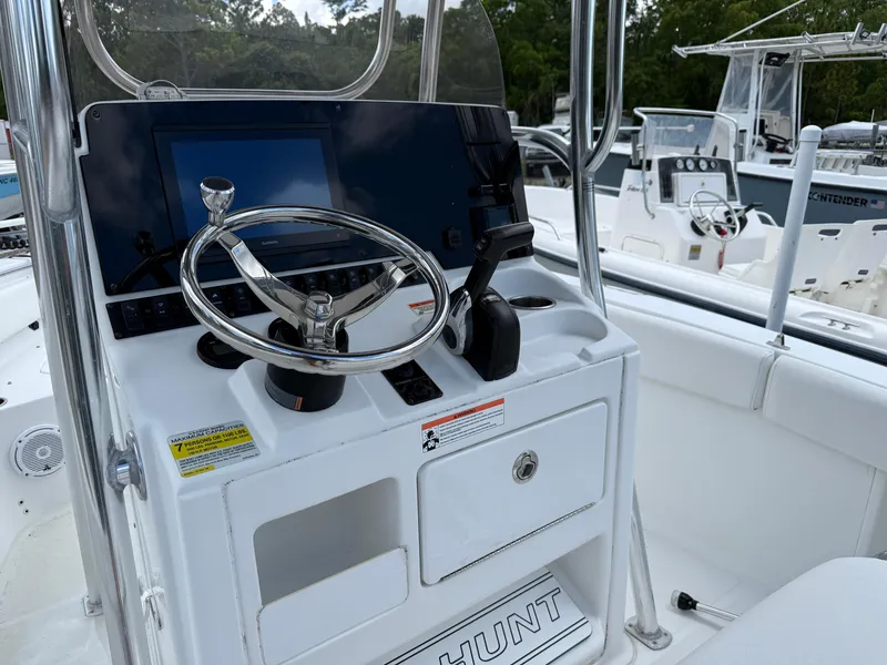 Slide: The Image of 2019 Sea Hunt Ultra 196 boat console with steering wheel and controls. - 7
