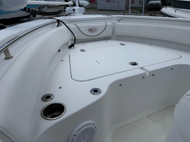 Slide: The Image of 2019 Sea Hunt Ultra 196 boat interior with storage compartment and cup holders. - 8