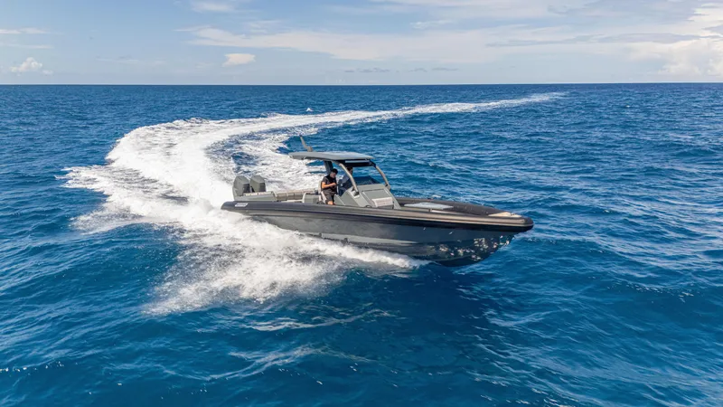 Slide: The Image of 2025 Skipper-BSK 38 boat cruising on open blue ocean under clear sky. - 25