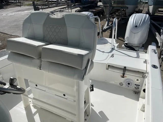 Slide: The Image of 2025 World Cat 235 CC boat interior with dual seats and outboard motor. - 4