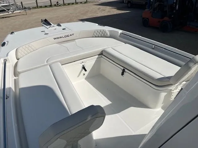 Slide: The Image of 2025 World Cat 235 CC boat interior with white seating and storage compartments. - 6