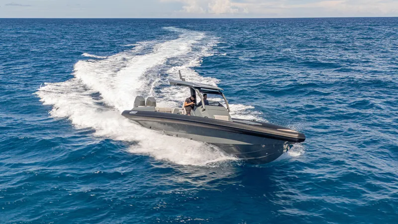 Slide: The Image of 2025 Skipper-BSK 38 boat cruising on open sea, leaving a white wake trail. - 24