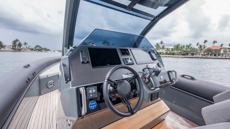 Slide: The Image of Cockpit of 2025 Skipper-BSK 38 boat with modern controls and scenic waterfront view. - 41