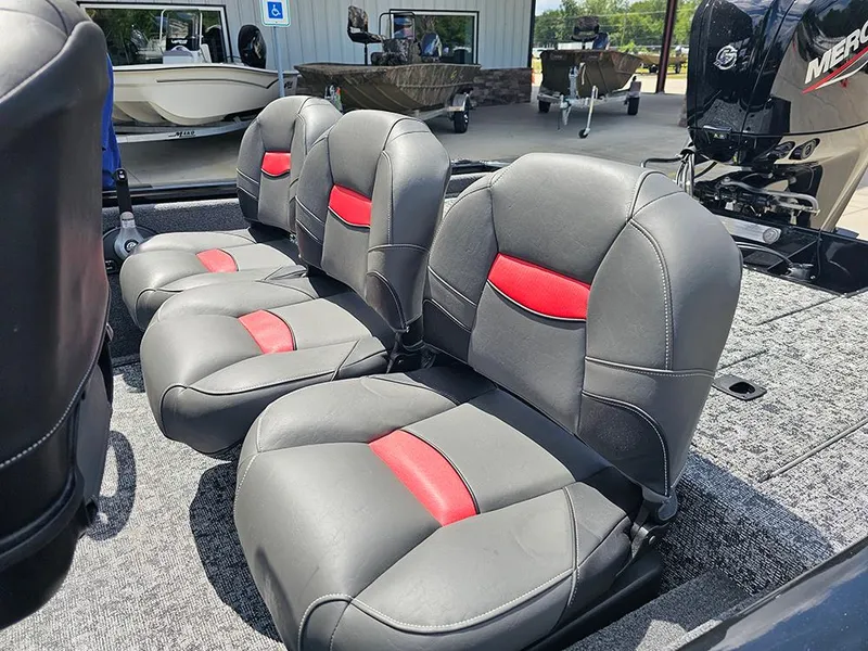 Slide: The Image of 2026 Tracker Pro Team 175 Crappie Edition boat seats with red accents, outdoor setting. - 14