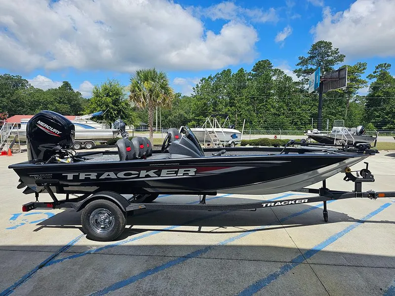 Slide: The Image of 2026 Tracker Pro Team 175 Crappie Edition boat on trailer, outdoors, under blue sky. - 6
