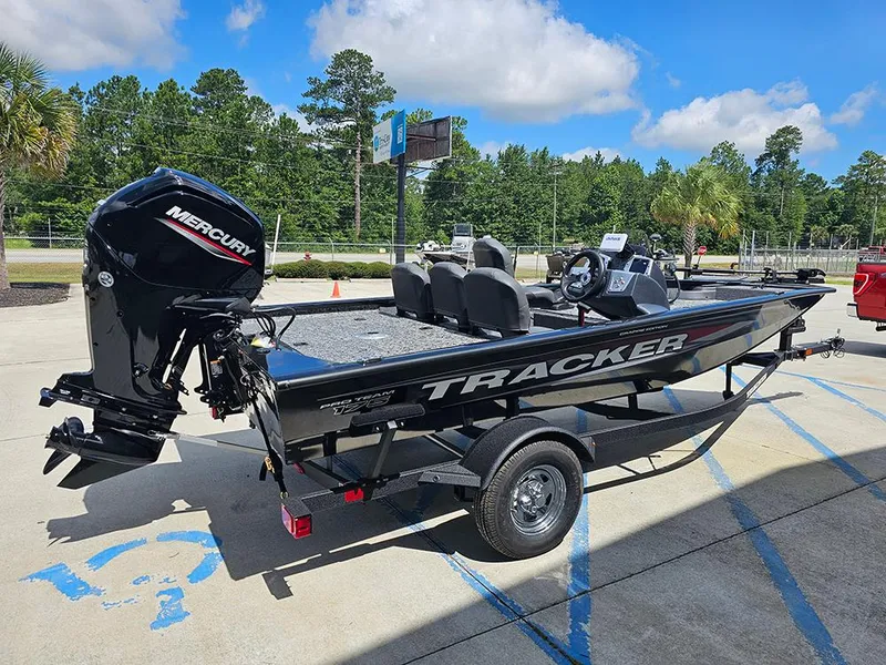 Slide: The Image of 2026 Tracker Pro Team 175 Crappie Edition boat with Mercury engine, parked outdoors. - 7
