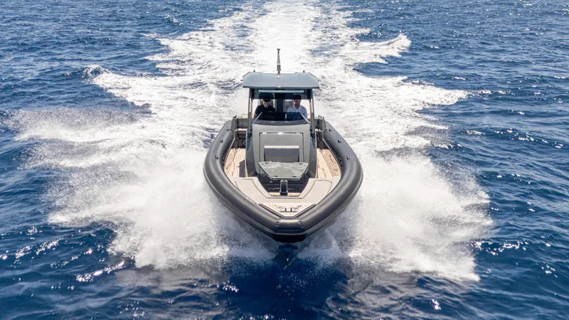 Slide: The Image of 2025 Skipper-BSK 38 boat cruising on open sea, creating a dynamic wake. - 11