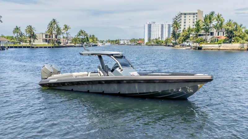 Slide: The Image of 2025 Skipper-BSK 38 boat on a scenic waterway with palm trees and buildings. - 36
