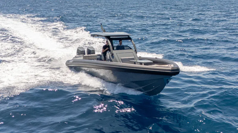 Slide: The Image of 2025 Skipper-BSK 38 boat cruising on open sea, creating a wake. - 9