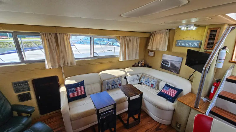 Slide: The Image of Interior of 1983 Chris-Craft 381 Catalina with cozy seating and nautical decor. - 12