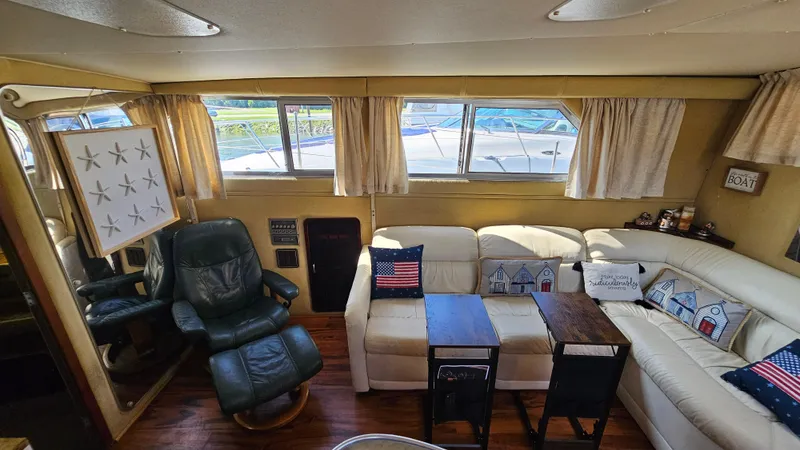 Slide: The Image of Interior of 1983 Chris-Craft 381 Catalina yacht with cozy seating and nautical decor. - 13