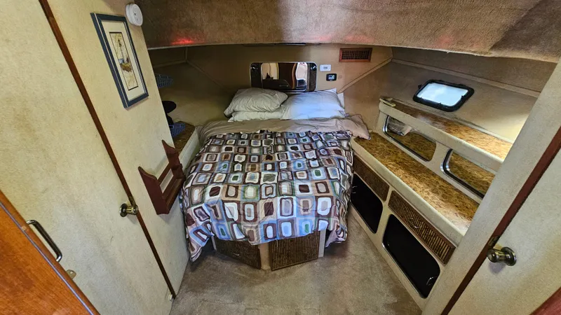 Slide: The Image of Cozy cabin interior of 1983 Chris-Craft 381 Catalina with bed and storage. - 18