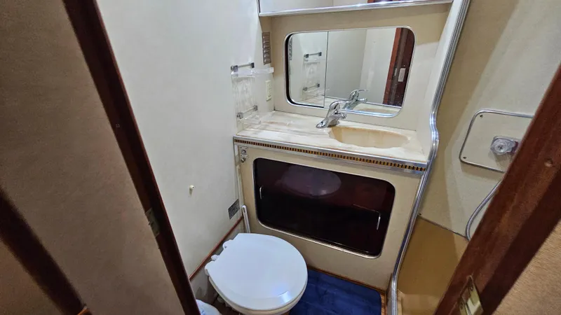 Slide: The Image of 1983 Chris-Craft 381 Catalina bathroom with sink, mirror, and toilet. - 19