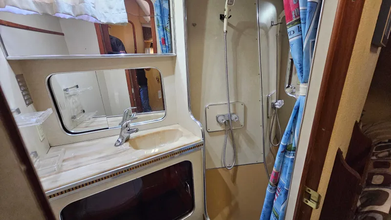 Slide: The Image of 1983 Chris-Craft 381 Catalina bathroom with sink, mirror, and shower area. - 20