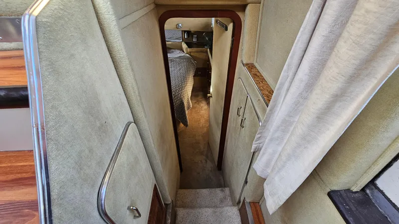 Slide: The Image of Interior view of 1983 Chris-Craft 381 Catalina yacht, featuring narrow hallway and cozy cabin. - 22