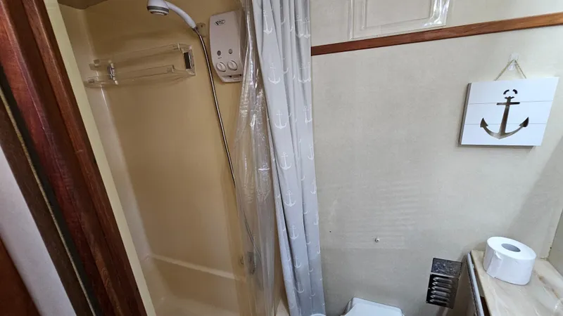 Slide: The Image of Bathroom interior of 1983 Chris-Craft 381 Catalina yacht with shower and nautical decor. - 27