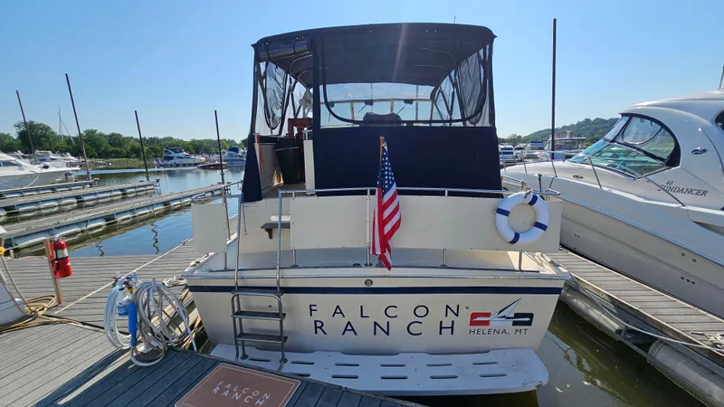 Slide: The Image of 1983 Chris-Craft 381 Catalina docked, featuring "Falcon Ranch" branding and American flag. - 4