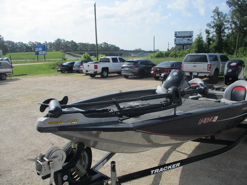 Slide: The Image of 2014 Bass Tracker PRO TEAM 190 boat on trailer in parking lot. - 2