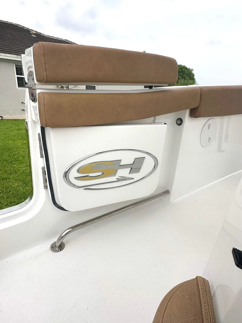 Slide: The Image of 2022 Sea Hunt Ultra 255 SE boat interior with tan seating and SH logo. - 10