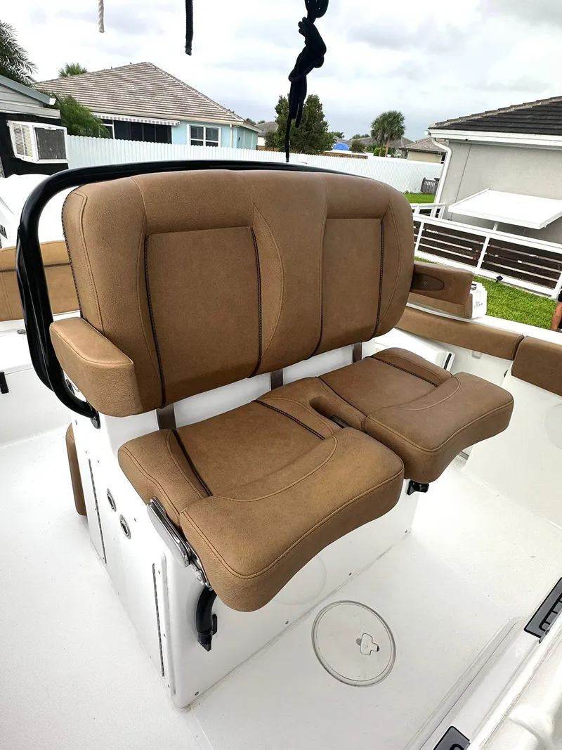 Slide: The Image of 2022 Sea Hunt Ultra 255 SE boat with tan cushioned seating. - 19