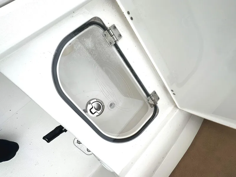 Slide: The Image of Storage compartment on 2022 Sea Hunt Ultra 255 SE boat, featuring a secure latch. - 21