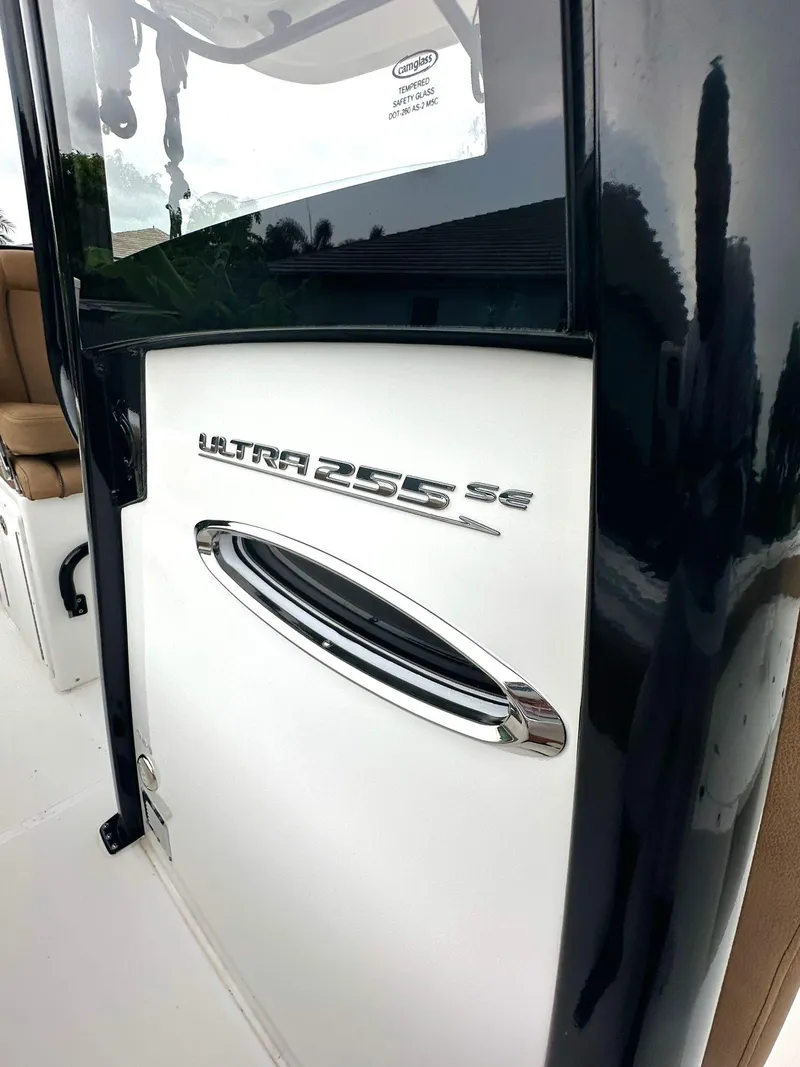 Slide: The Image of 2022 Sea Hunt Ultra 255 SE boat door with logo and handle. - 22