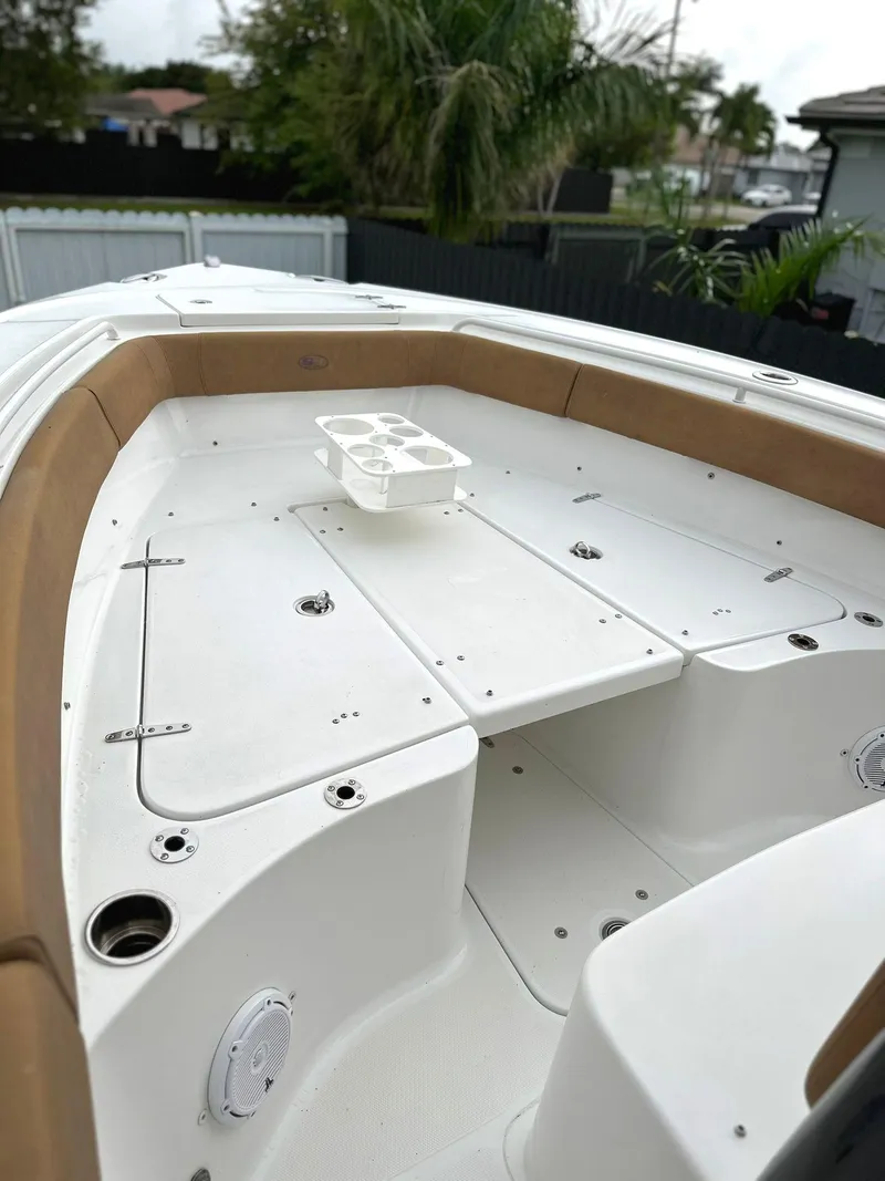 Slide: The Image of 2022 Sea Hunt Ultra 255 SE boat deck with seating and cup holders. - 28