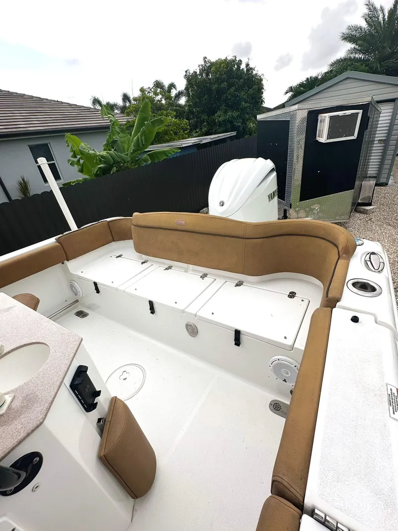 Slide: The Image of 2022 Sea Hunt Ultra 255 SE boat interior with cushioned seating and storage compartments. - 33