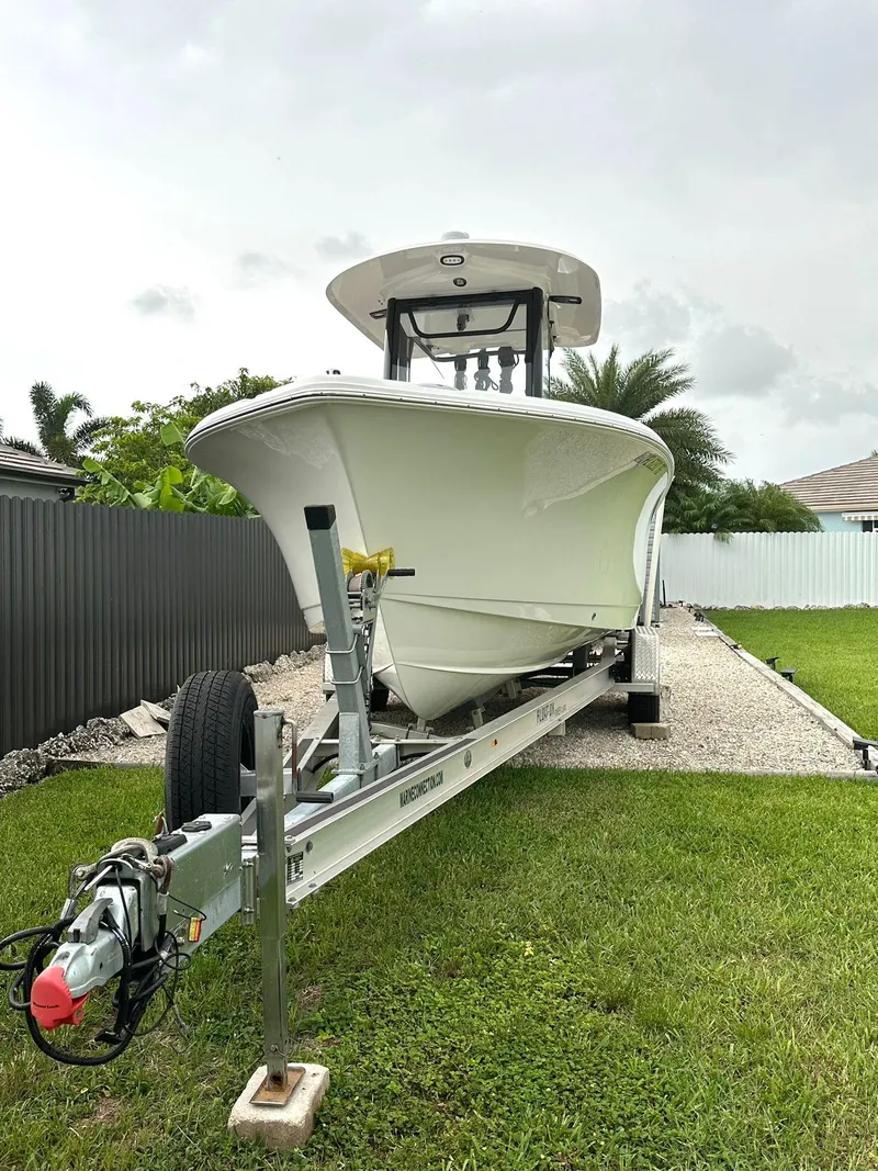Slide: The Image of 2022 Sea Hunt Ultra 255 SE boat on trailer in a residential yard. - 6
