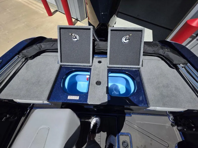 Slide: The Image of 2025 Nitro ZV19 Sport Pro boat with open storage compartments and blue interior. - 17