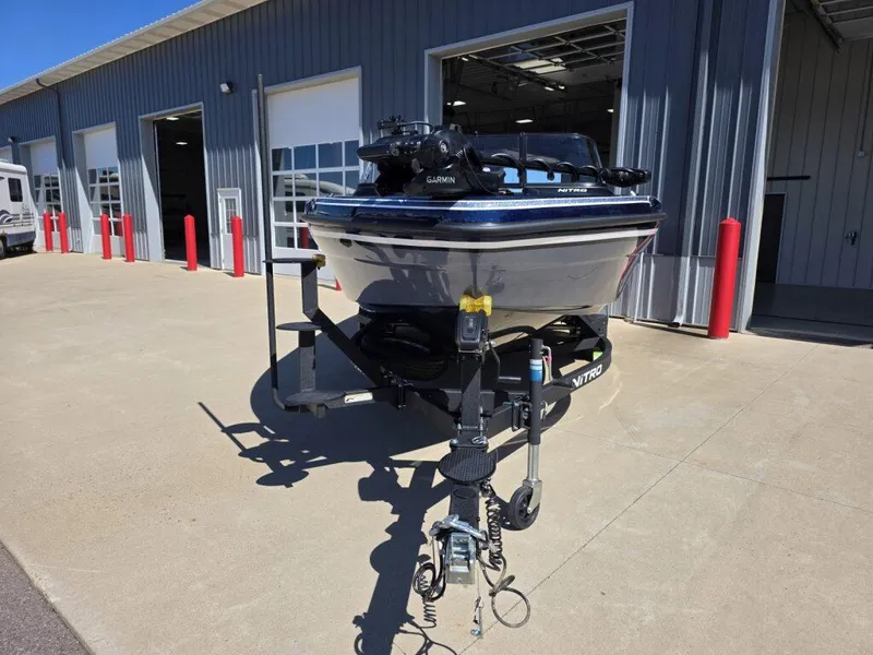 Slide: The Image of 2025 Nitro ZV19 Sport Pro boat on trailer outside a garage. - 2