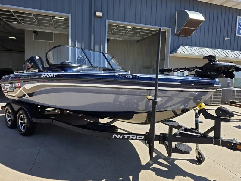 Slide: The Image of 2025 Nitro ZV19 Sport Pro boat on trailer, parked outside a building. - 3