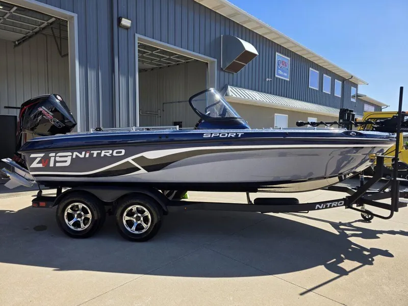 Slide: The Image of 2025 Nitro ZV19 Sport Pro boat on trailer, parked outside a building. - 4