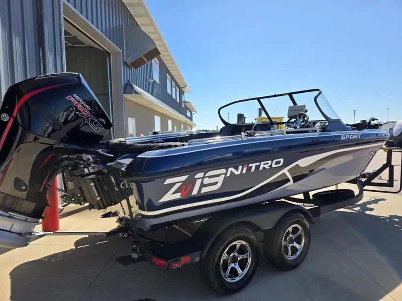 Slide: The Image of 2025 Nitro ZV19 Sport Pro boat on trailer, parked outdoors, featuring sleek design and powerful engine. - 5