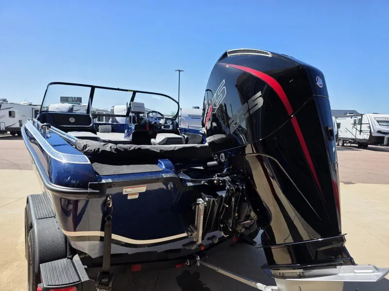 Slide: The Image of 2025 Nitro ZV19 Sport Pro boat with powerful outboard motor, parked outdoors. - 7