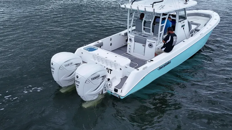 Slide: The Image of 2023 Everglades 365 CC boat with dual Yamaha engines on the water. - 10