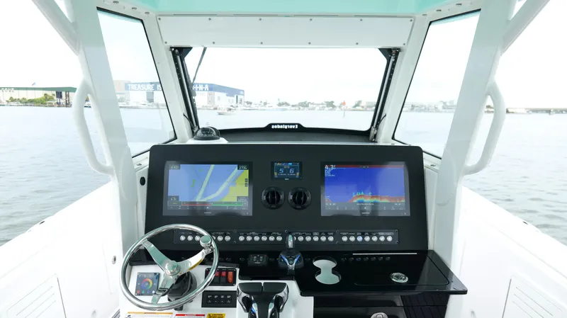 Slide: The Image of 2023 Everglades 365 CC boat dashboard with navigation screens and steering wheel. - 14