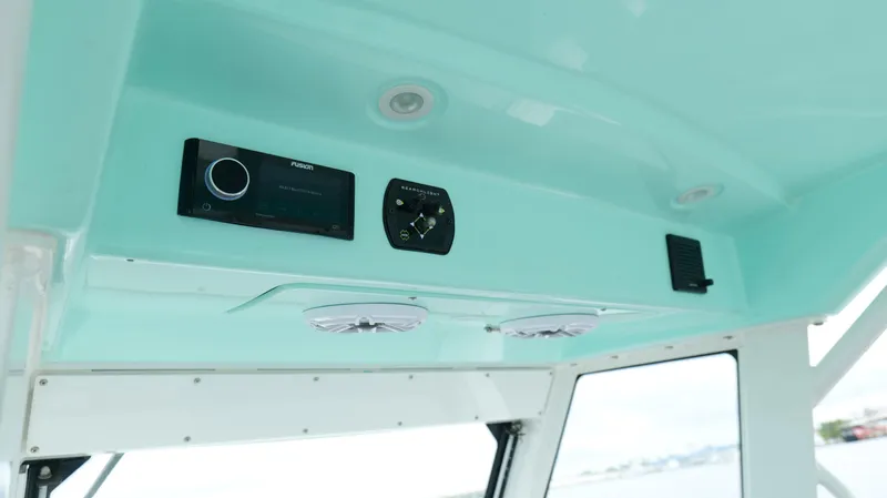 Slide: The Image of Interior view of 2023 Everglades 365 CC boat's control panel and speakers. - 16