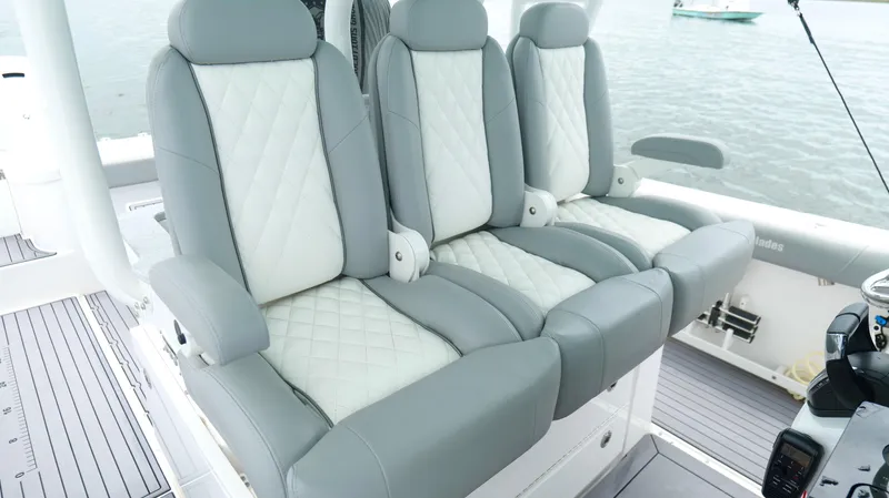 Slide: The Image of Luxury seating on 2023 Everglades 365 CC boat, featuring gray and white quilted upholstery. - 18